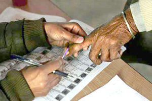 An Indian polling official marks the finger of a man with indelible ink before he proceeds to cast his vote at a polling station in a village along the India-Pakistan border about 46 kilometers (29 miles) from Amritsar, India, Monday, Jan. 30, 2012. More than 20 million people in two northern states go to the polls in key elections expected to reflect the popularity of India's ruling Congress party. (AP Photo/Altaf Qadri)